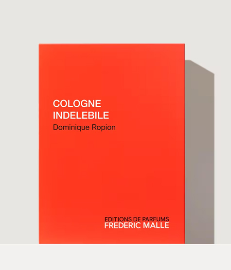 Eine leuchtend rote Schachtel mit dem Text „COLOGNE INDELEBILE” und „Dominique Ropion” in Weiß, unten mit „EDITIONS DE PARFUMS FREDERIC MALLE”.