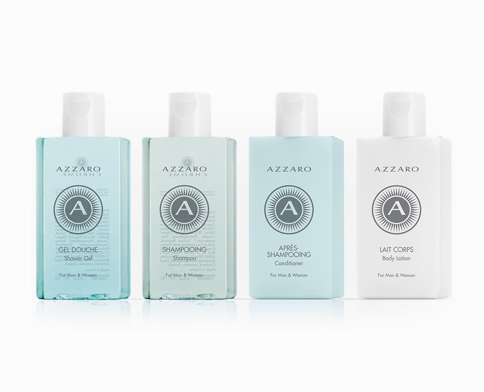 Four bottles of Azzaro skincare products are displayed, including shower gel, shampoo, conditioner, and body lotion, all featuring a light blue and white color scheme.