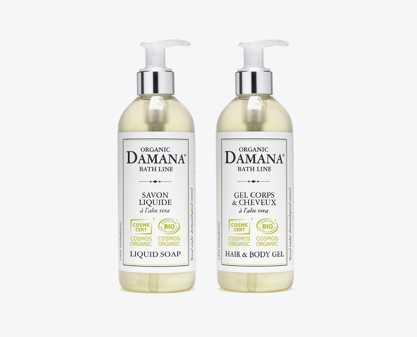 Duas garrafas de produtos de banho orgânicos da marca Damana, uma rotulada como sabonete líquido e a outra como gel para cabelo e corpo, ambas com dispensadores transparentes com bomba. Cada garrafa apresenta um rótulo branco com detalhes em verde, indicando a sua certificação orgânica.