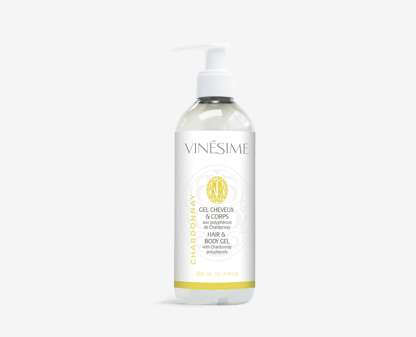 Um frasco transparente de gel para cabelo e corpo Vinésime , com dispensador e rótulo branco com detalhes dourados. O frasco contém 350 ml de produto.