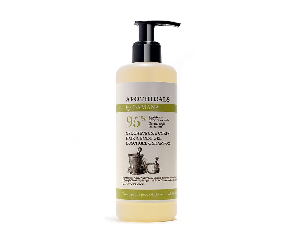 Um frasco translúcido de gel para cabelo e corpo com tampa de bomba, rotulado como «Apothicals by Damana», indicando 95% de ingredientes naturais e fabricado em França. O rótulo apresenta uma ilustração de ferramentas utilizadas na preparação de ervas.