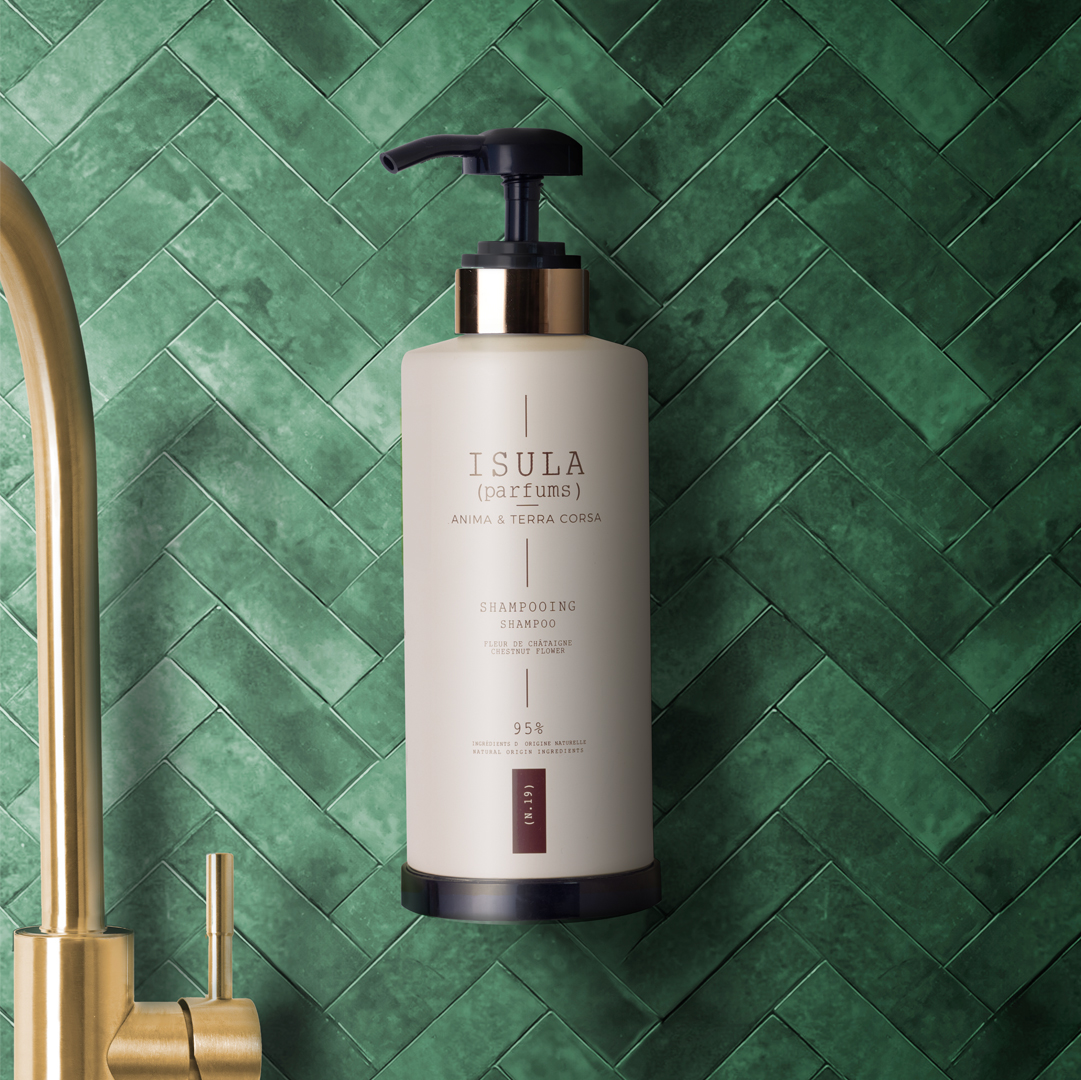Isula Isula Parfums Shampooflasche mit Pumpe, angebracht an einer grün gefliesten Wand in der Nähe eines Wasserhahns
