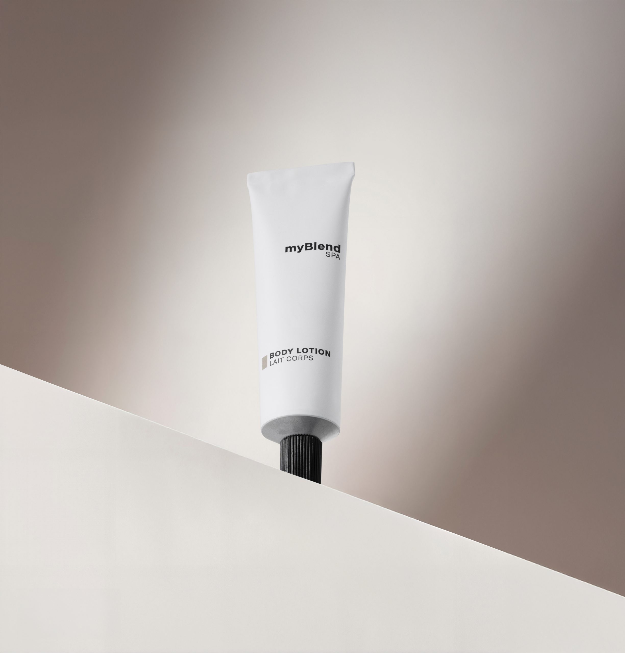 myBlend Spa body lotion tube with black cap displayed on a minimalist white surface against a soft neutral background