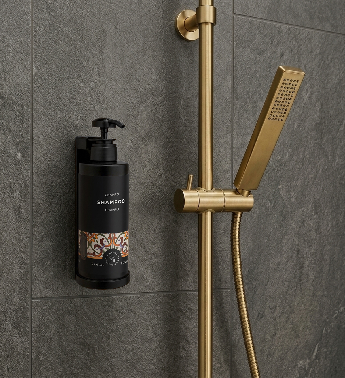 Luxury shampoo dispenser mounted in a modern shower with brushed gold fixtures.